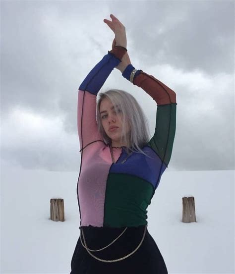 Pop star Billie Eilish appears to tease showing off her nude tits and ass in the scandalous selfie photos above. Being the degenerate Jezebel that she is, Billie did not stop at just flaunting her naked sex organs, as she also engages in sexually suggestive behavior with an animal by getting her bulbous boobies pawed in the video clip below.